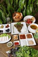 Wooden Table Adorned With Plates of Delicious Food photo