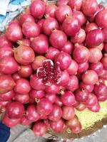 a person standing next to a large bowl of onions photo