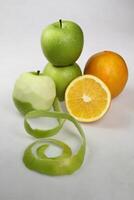 a pile of green apple fruit and orange fruit isolated on white background photo