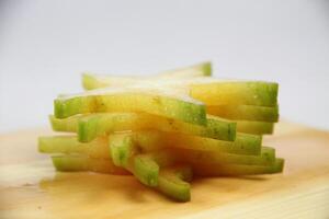 slices of starfruit well arranged on wooden cutting board photo