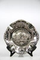 a silver plate with a picture of a merlion on it photo