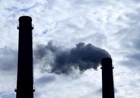 Toxic smoke emitted from industrial plant smokestacks photo