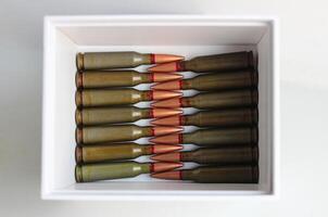 Rifle Bullets In Head To Head Order In White Cardboard Box photo