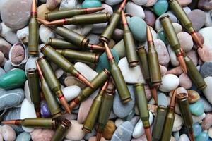 Pattern Of Scattered Bullets On A Round Smooth Rocks Top View photo