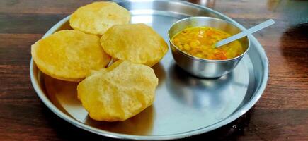 Chole or Chickpea curry and poori, Indian food photo