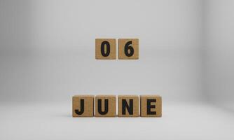 wooden cubes with arranged letters. June and 06 on blurry white background photo