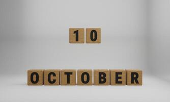 wooden cubes with arranged letters. October and 10 on blurry white background photo