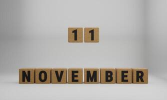 de madera cubitos con arreglado letras. noviembre y 11 en borroso blanco antecedentes foto