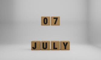 wooden cubes with arranged letters. July and 07 on blurry white background photo