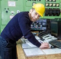 industrial worker at the work in factory photo