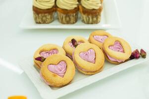 Desserts for the holiday, shortbread cookies in the shape of a heart with marshmallows photo