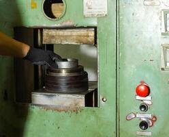 close up of a man using a machine, close up of a man working on a machine photo