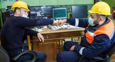 industrial workers at the work in factory photo