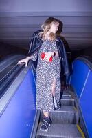 the beautiful young woman on the escalator photo