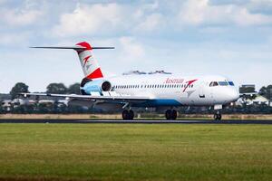 Amsterdam, Netherlands, 2014 - Austrian Airlines passenger plane at airport. Schedule flight travel. Aviation and aircraft. Air transport. Global international transportation. Fly and flying. photo