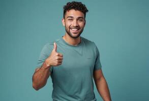 AI Generated A friendly man in a teal t-shirt gives a thumbs up, his smile warm and inviting. photo