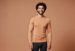 AI Generated A man with curly hair presents a friendly demeanor in a peach long-sleeve shirt. photo