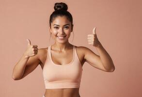 AI Generated An enthusiastic woman in a pink sports bra gives a thumbs up, her confidence and positivity shining through. photo