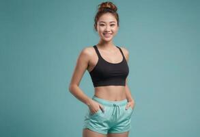 AI Generated A young woman in a black sports bra and teal shorts, with a high ponytail, ready for a workout session. photo