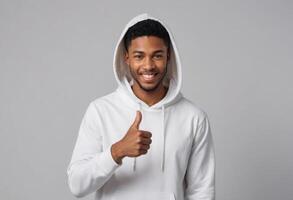 AI Generated A cheerful young man in a white hoodie giving a thumbs up. His bright smile and casual attire reflect a relaxed and positive lifestyle. photo