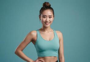 AI Generated A fit Asian woman in a teal sports bra stands with hands on hips, exuding confidence and readiness. photo