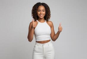 AI Generated A young woman with curly hair and a white tank top shows enthusiastic approval with two thumbs up. Her modern look and beaming smile portray positivity. photo