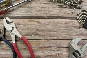 Old tools on wooden floor. Renovation, maintenance and repairing concept. photo