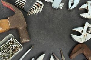 Old tools on concrete floor. Renovation, maintenance and repairing concept. photo