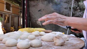 hands form pieces of dough for baking bread and rolls. video