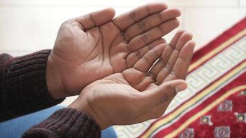 muslim man keep hand in praying gestures during ramadan, Close up video