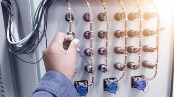 Checking the electrical power on the control panel using a test pen. photo