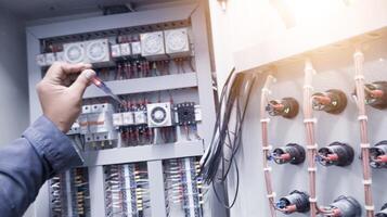 Checking the electrical power on the control panel using a test pen. photo