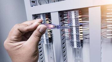 Checking the electrical power on the control panel using a test pen. photo