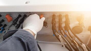 Checking and measuring solar panels using a multimeter, repairing power cable lines in solar panel inverters. photo