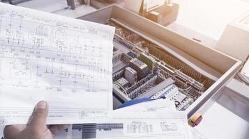 Looks at the electrical drawing on the background of the automation panel.For conceptual analysis trouble shooting electrical control. photo