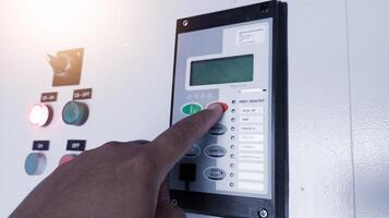 The Technician setting the parameter of the Over Current Rellay on control cubicle panel. photo