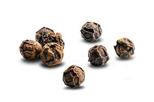 View of dried natural black pepper seeds, Piper nigrum, on white background with clipping path photo