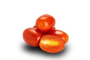 Side view pile of whole and a half plum tomatoes on white background with clipping path. Tomatoes are source of the antioxidant lycopene which reduced risk of heart disease and cancer. photo