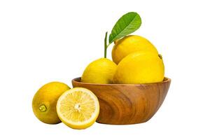 Lemons whole and half with leaves in wooden bowl on white background with clipping path. photo