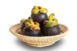 Pile of ripe mangosteen in bamboo basket isolated on white background with clipping path. photo