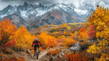 ai generado ciclista montando mediante un escabroso montaña camino, con vibrante otoño follaje creando foto