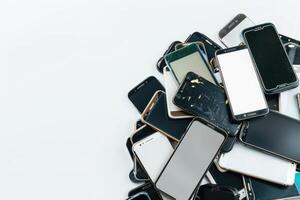 AI generated Pile of old mobile phone. Heap of the different smartphones isolated on white background. photo