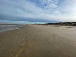 the coast at low tide with beach in the early morning of De Haan, Belgium photo