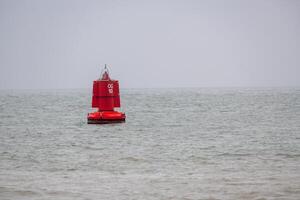 Red buoy as a lane marker for ocean-going vessels photo