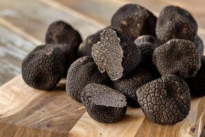 AI generated Black truffles on the cutting board. photo