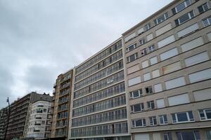 large narrow house facades with windows and balconies photo