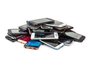 AI generated Pile of old mobile phone. Heap of the different smartphones isolated on white background. photo