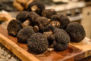 AI generated Black truffles on the cutting board. photo