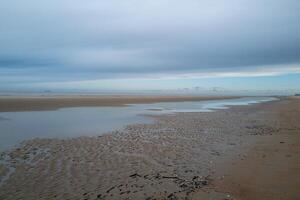 the coast at low tide with beach in the early morning of De Haan, Belgium photo