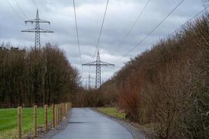 Street  with electric pylons in the landscape photo